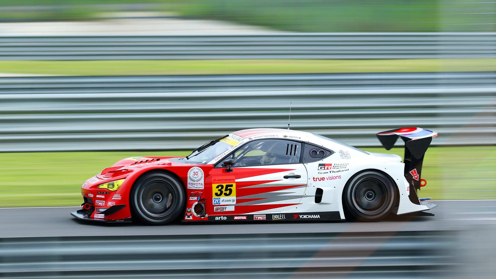 A Racing Car Driving at High Speeds on a Track