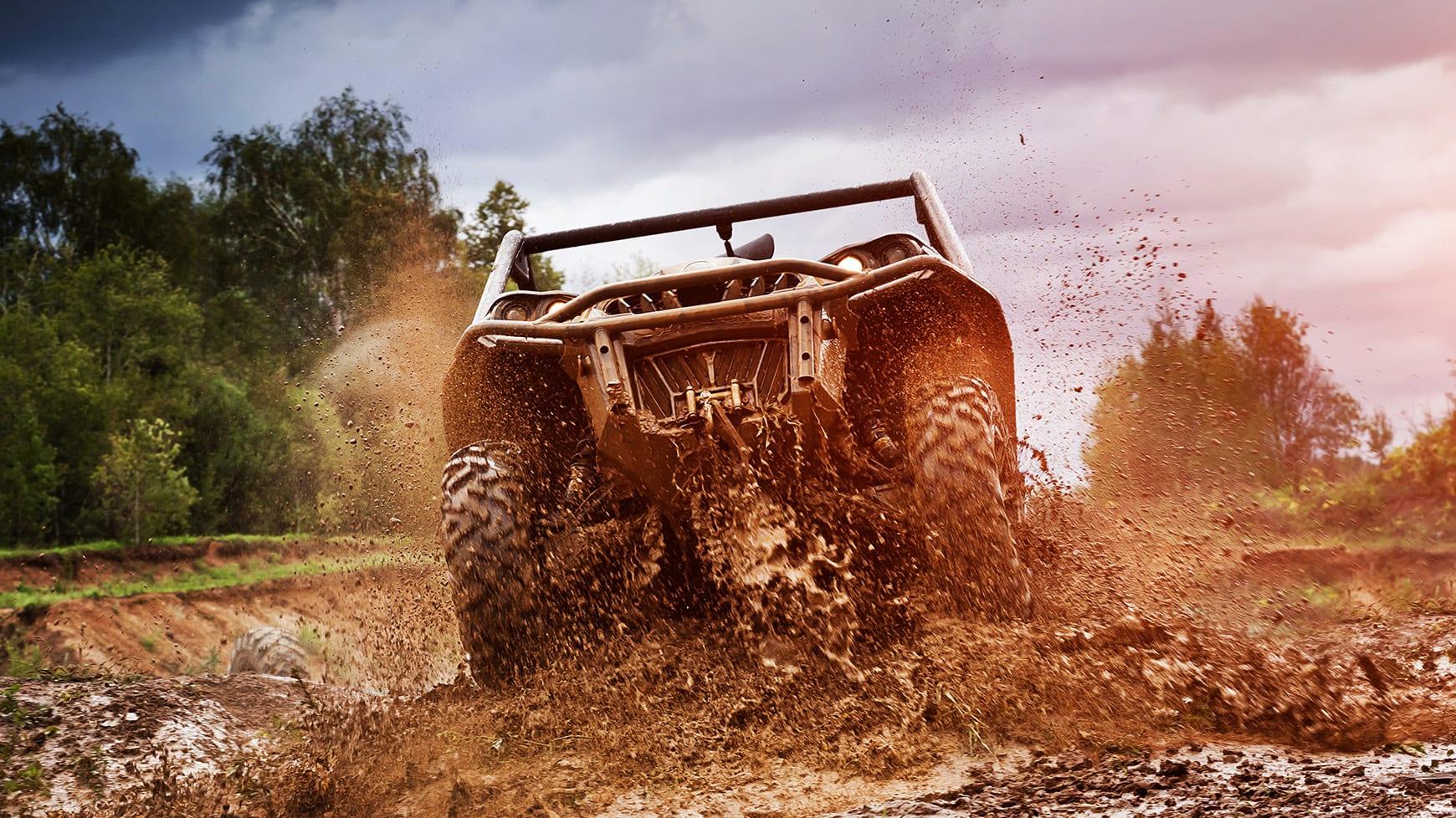 ATV Driving Through Mud Equipped with Mud Tires